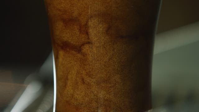 Close-Up of Dark Nitro Beer Cascading in (Pouring into) a Clear Glass