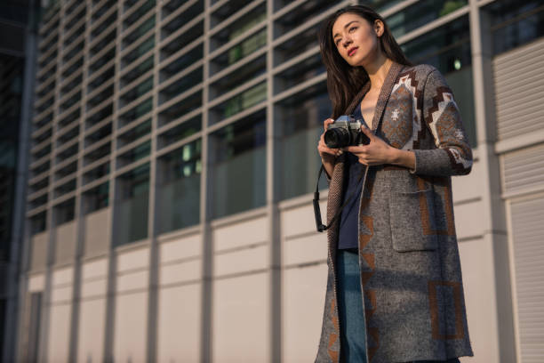 istock Pretty woman with photo camera 1134749588