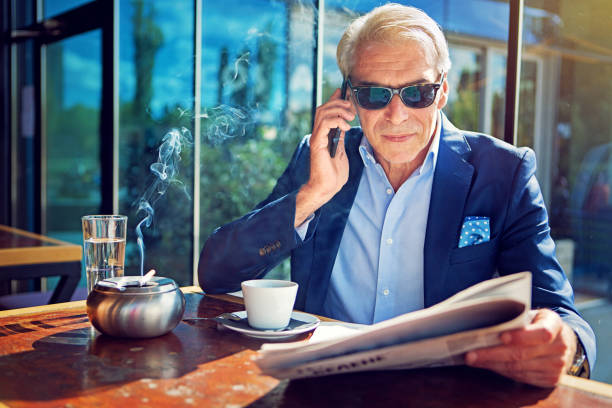 istock Businessman is talking using his mobile phone in cafeteria 1134749972