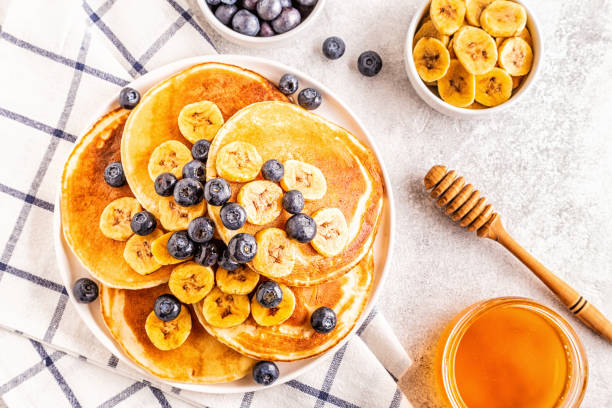 istock Pancakes with banana,  blueberries on white plate 1134750823