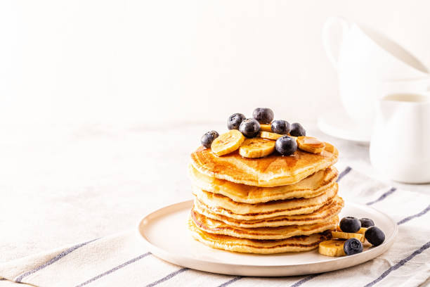 istock Pancakes with banana,  blueberries on white plate 1134750857