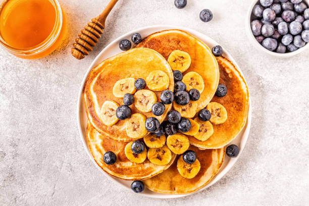 istock Pancakes with banana,  blueberries on white plate 1134750902