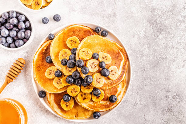 istock Pancakes with banana,  blueberries on white plate 1134751009