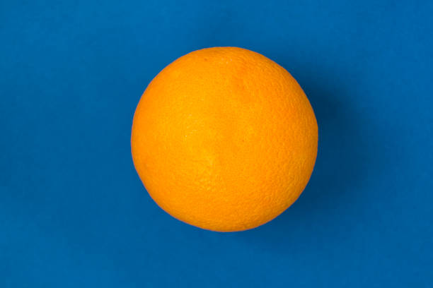 istock Ripe orange isolated on dark blue background. 1134751453