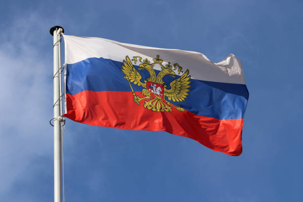 istock Russian flag waving against the blue sky and white clouds 1134753156
