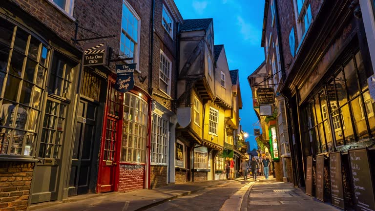 Time-lapse: Tourist Pedestrian Commuter Crowd at York shamble shopping area in York England Uk at dusk