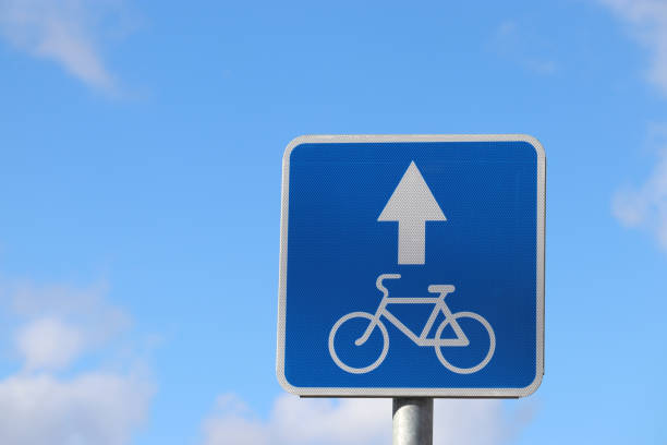 istock Bicycle road sign isolated on blue sky 1134753636