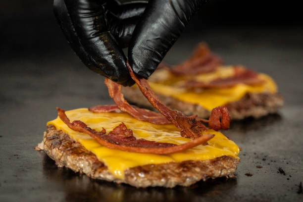 Cooking Bacon cheese burger Hand glove bacon cheeseburger stock pictures, royalty-free photos & images