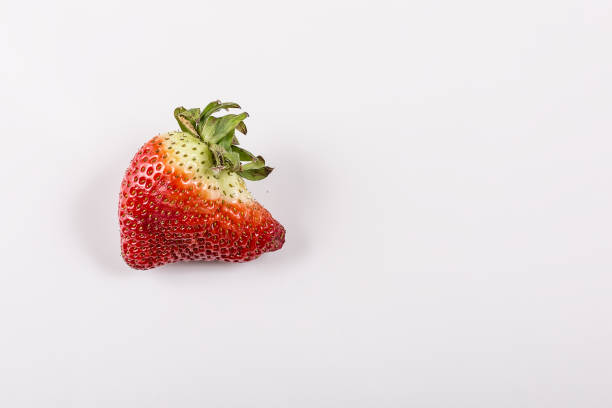 istock Ugly organic strawberries isolated on white background 1134755444