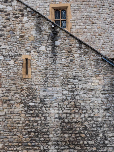 istock An old stone wall with a narrow window and angled roof 1134757858