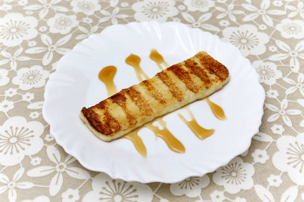 High Angle Close-Up Of Toasted Breads With Honey In Plate On Table