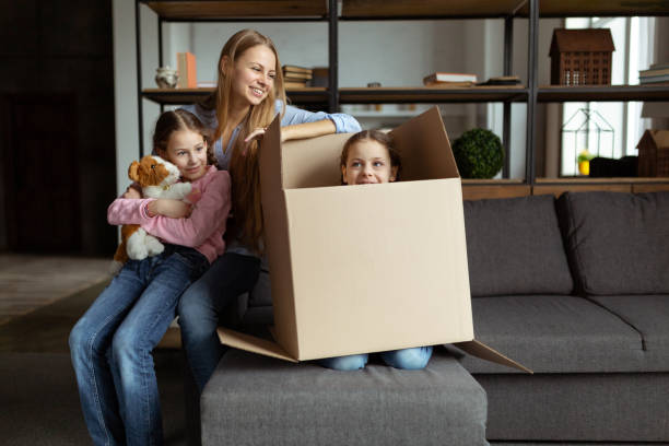 istock Exited child girl hiding in cardboard having fun 1134758384