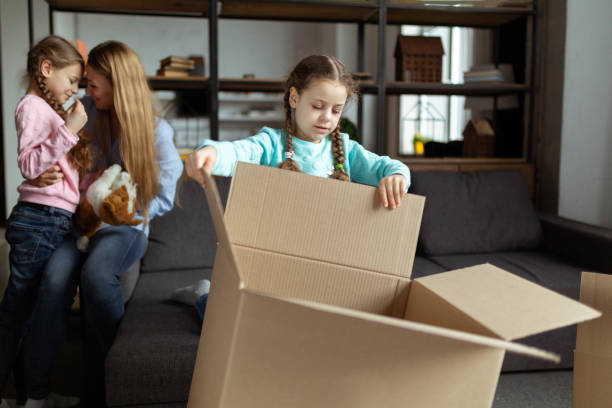 istock Family unpacking cardboard boxes at new home 1134758915