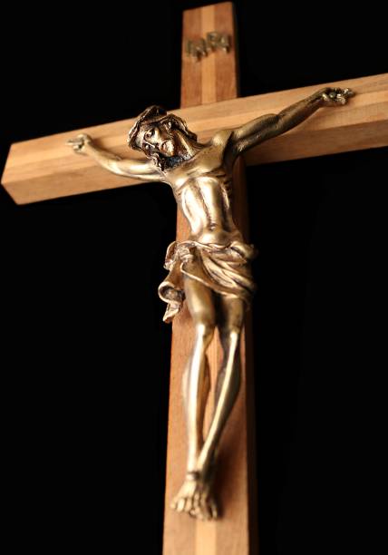 istock Looking up at crucifix isolated on black 1134759502