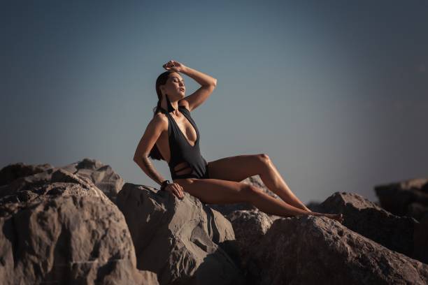 Beautiful athletic girl in a swimsuit on the background of the sea