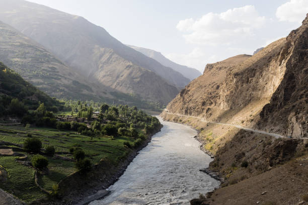 Border river Panj River in Wakhan valley with Tajikistan right and Afghanistan left stock photo