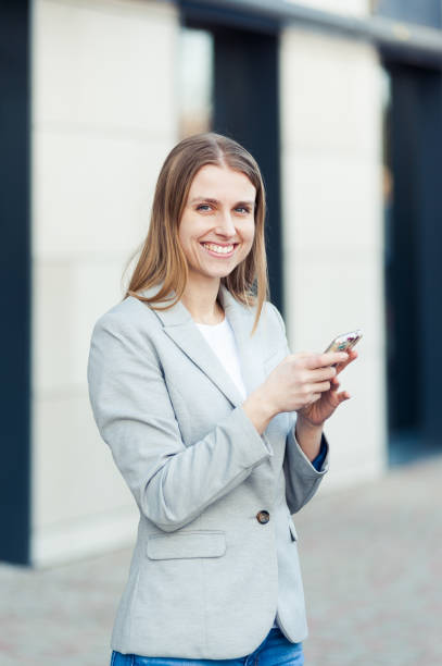 istock Beautiful young businesswoman using smartphone 1134761684
