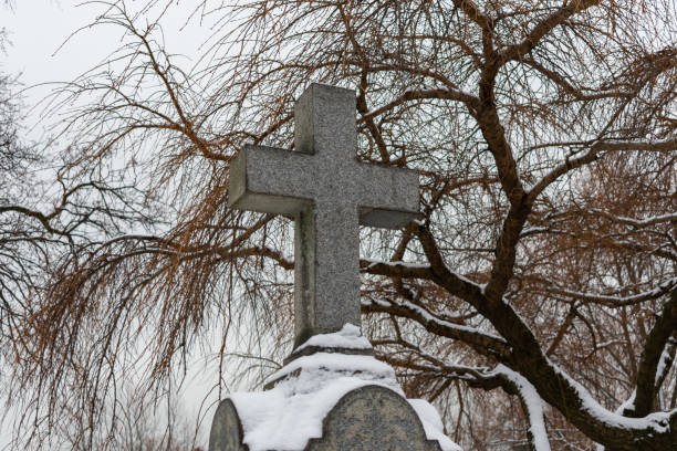 istock Cross on top of a Tombstone at a Cemetery 1134761966