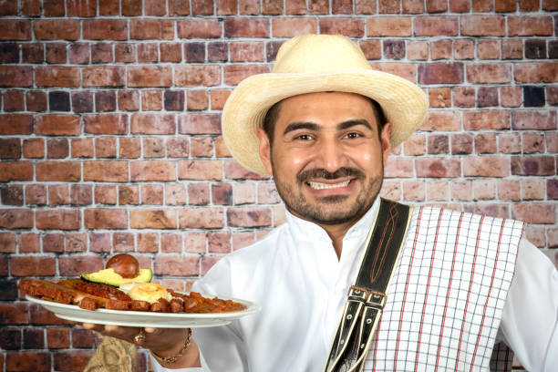 istock Colombian man holding a bandeja paisa (typical Colombian dish) 1134772407