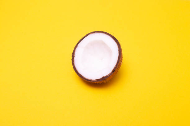 istock Half coconut on yellow background. Top View. Bright pattern minimal style. Pop art design, creative concept 1134776207