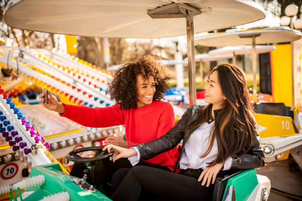 istock Two friends riding amusement park ride 1134781026