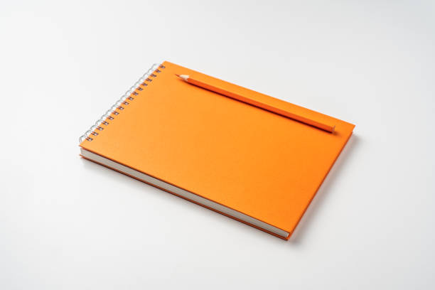 istock perspective view of spiral orange notebook 1134782981