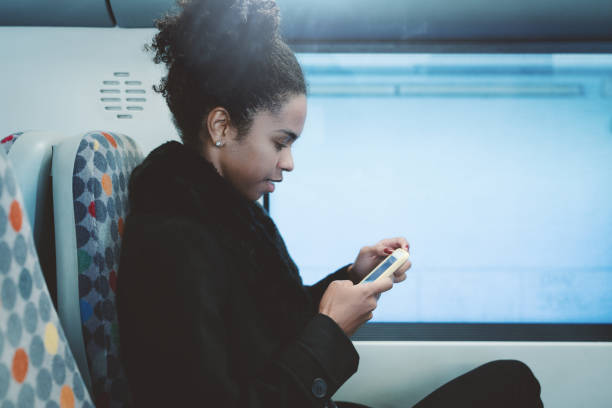 istock Girl with cellphone in suburban train 1134788086