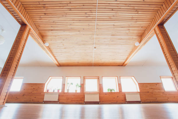 istock Gym wood interior with black yoga mat, small windows, no people. Copy space. 1134790076