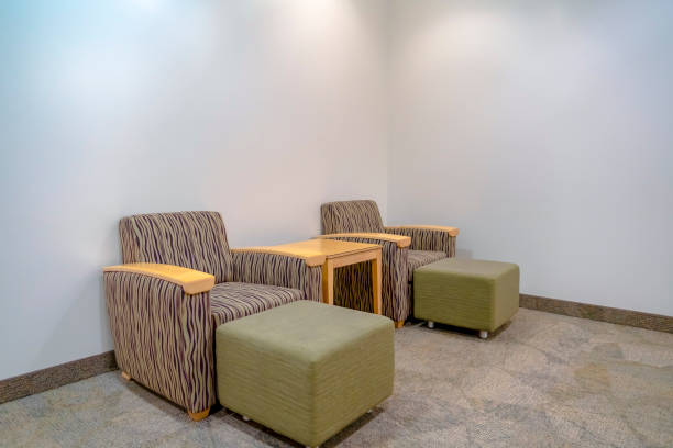 istock Armchairs with foot rests against white wall 1134795652
