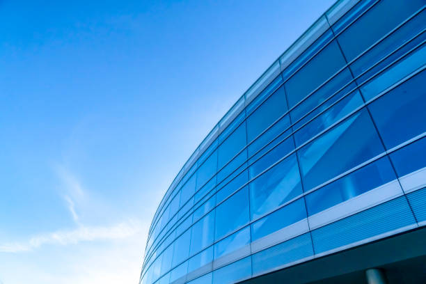 istock Blue glass windows of a building against blue sky 1134795655