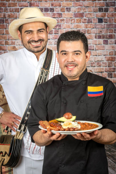 istock Colombian Chef and farmer holding a bandeja paisa (typical Colombian dish) 1134795817