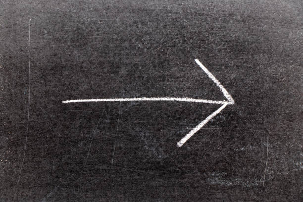 istock White chalk hand drawing in arrow shape on black board background 1134796864