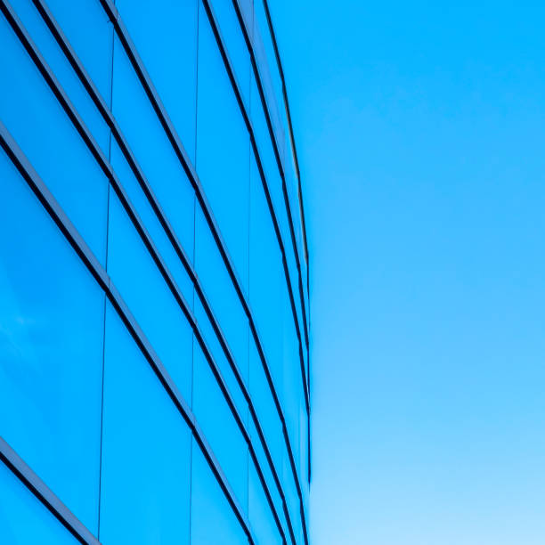 istock Reflective glass windows of building against sky 1134799373