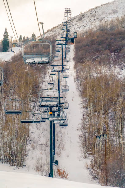 istock Ski lifts passing above a mountain slope in Utah 1134799408