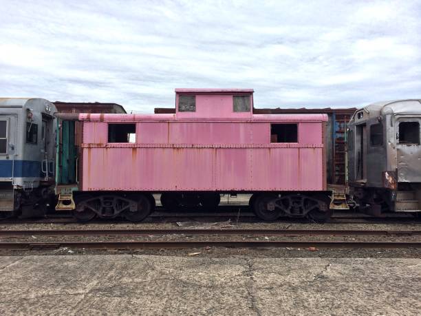 istock Rusty vintage pink caboose train car 1134803910