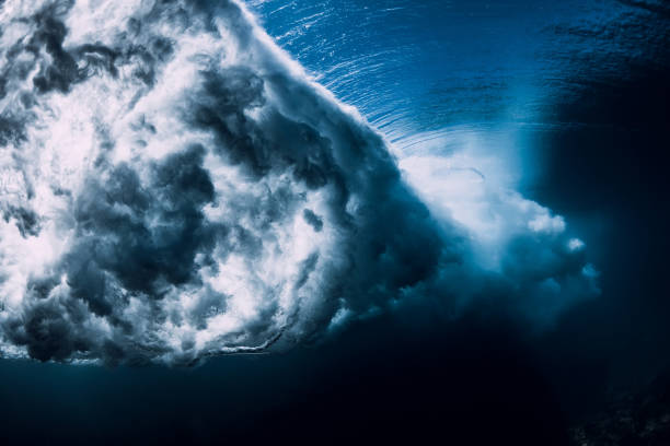 istock Wave underwater with air bubbles and sun light. Ocean in underwater 1134805361