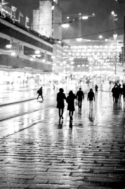 istock Bright city with people in the rain 1134806549