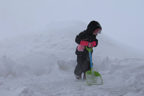 istock Child Shoveling Snow in a blizzard 1134807195