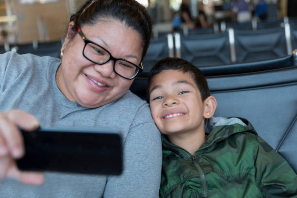 istock Waiting in an Airport Terminal Mom and Son 1134807302