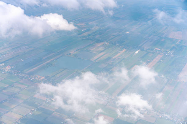 istock Beautiful white clouds float on the blue sky above the fields view from airplane 1134811075
