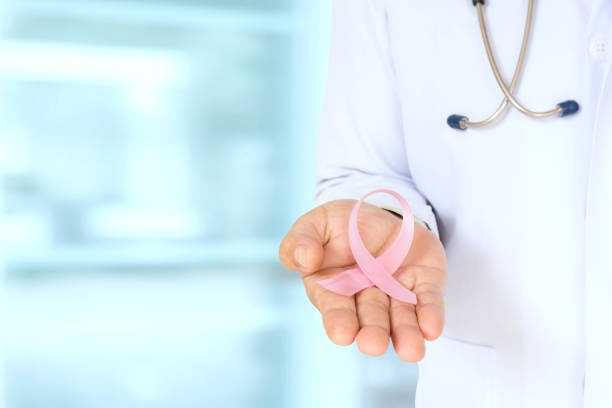 istock Doctor with pink ribbon concept in office. 1134817630