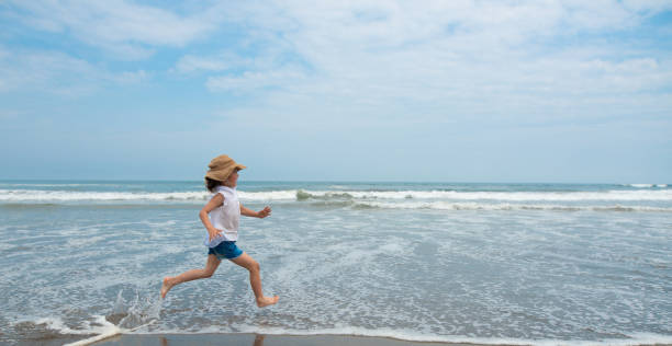 istock Girl running on the beach 1134819272