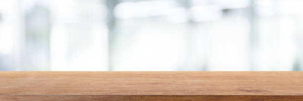 istock Empty wood table top and blur glass window wall in office building background - can used for display or montage your products. 1134819305
