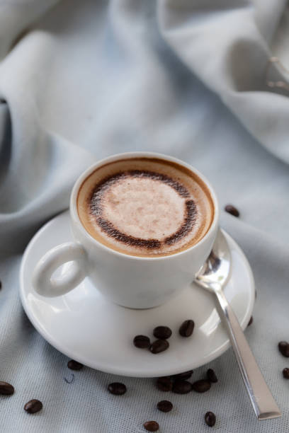 istock Hot coffee on a wooden table with flowers 1134819322
