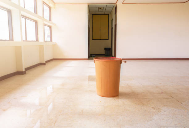 istock water leak drop interior office building in red bucket from Ceiling and flow on terrazzo floor 1134822106