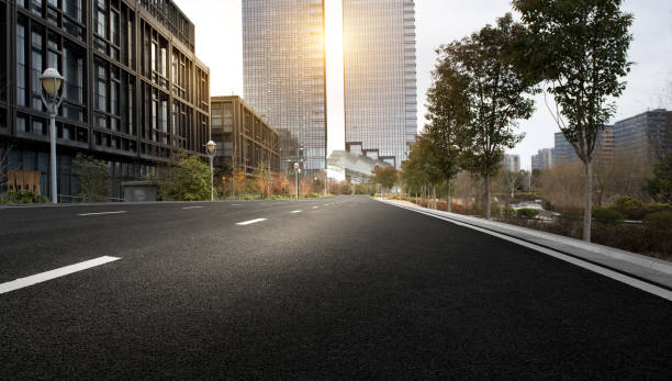 istock Asphalt pavement and modern architecture of city highway 1134829781