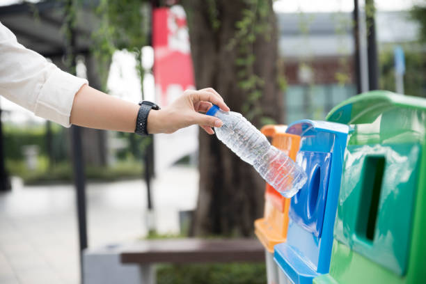 istock Closeup portrait woman hand throwing empty plastic water bottle in recycling bin. 1134829817
