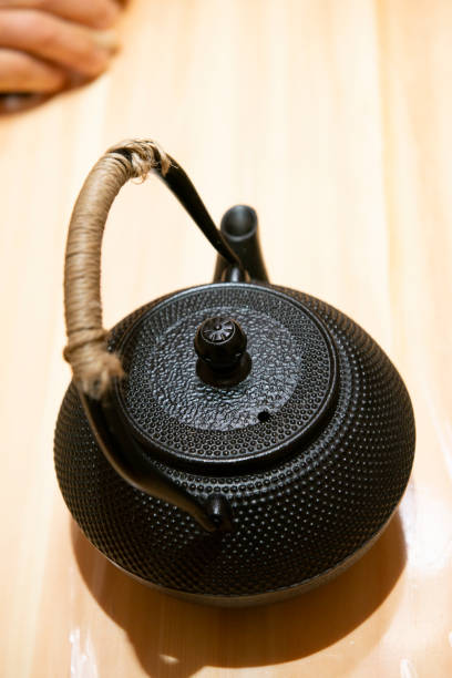 istock Japanese traditional black iron flat round teapot 1134830464