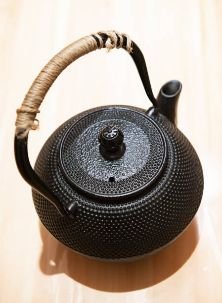 istock Japanese traditional black iron flat round teapot 1134830475