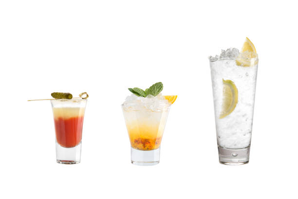 A variety of alcoholic drinks, beverages and cocktails on a white background. Three refreshing drinks in different glass goblets. Isolated.